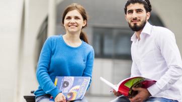 students outside with books